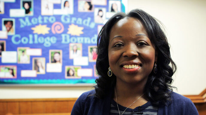 Dr. Yaa Owusu in front of a bulletin board at the Midtown Education Foundation.