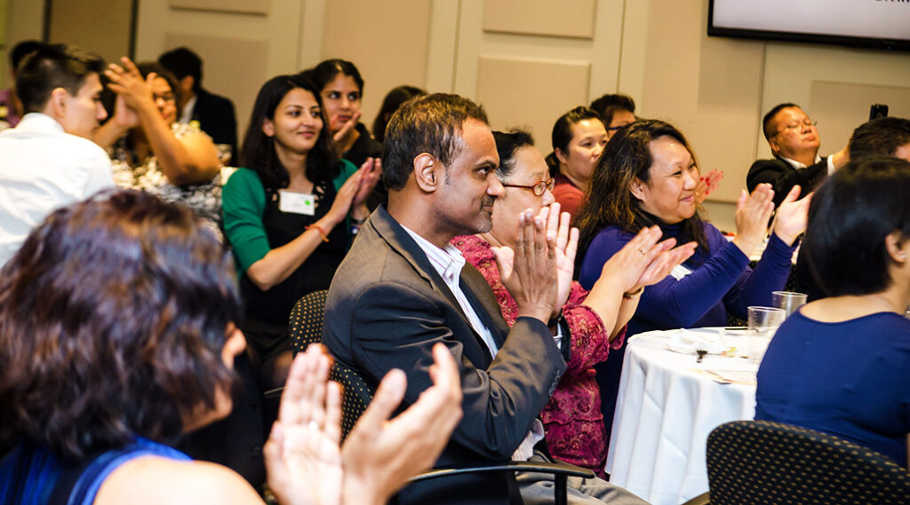 Guests applauding at the Asian Giving Circle reception|Guests in animated conversation|i2i’s Leakhena Yoeun talks with SAAPRI incoming executive director Reema Kapur