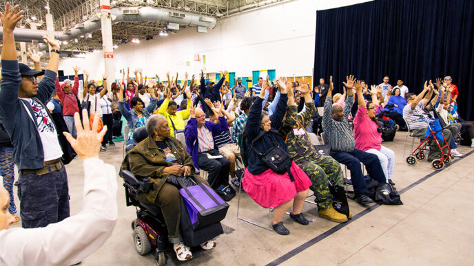 Individuals listen to a speaker at the Access Chicago Expo.