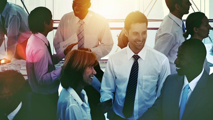 Professionals talking and laughing together in an office|Ring charts showing the racial and ethnic representation in Chicago’s population