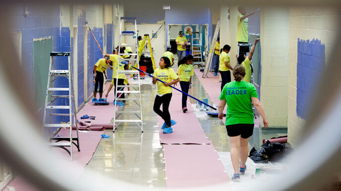 Students repaint a school hallway