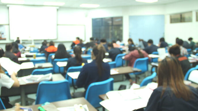 Students seated at desks in a high school classroom.