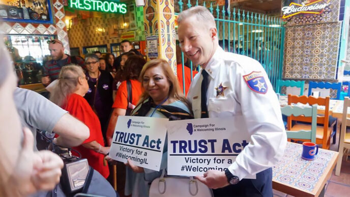 A uniformed sheriff and a Latina woman stand side by side