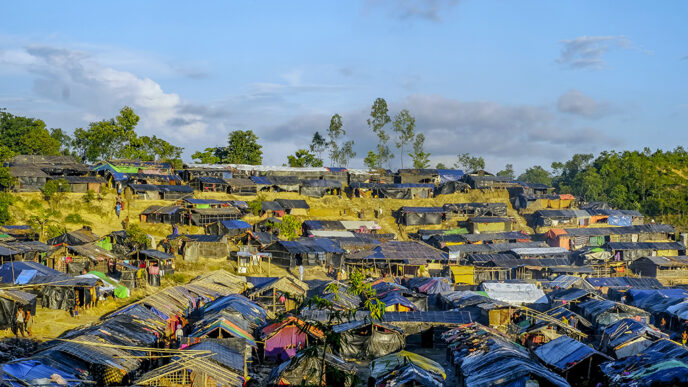 Rows of tents and bamboo shelters.