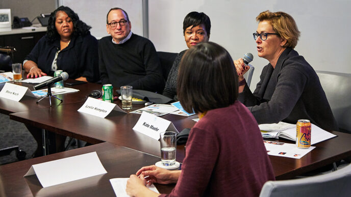 A group of panelists seated at a long conference table|A group of panelists seated at a long conference table|A group of panelists seated at a long conference table|A panelist speaks into a microphone|A group of panelists seated at a long conference table||Map of the Chicago region showing rates of food insecurity||.