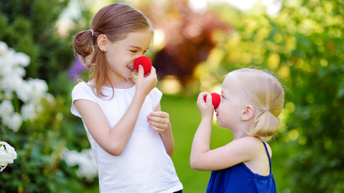 Two girls stand in a garden