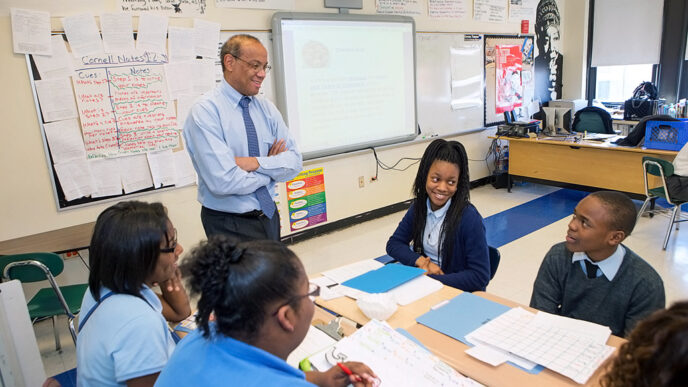 A man stands in a classroom.