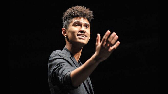 Young man telling story on stage|