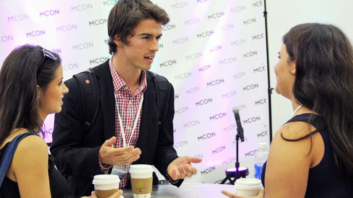 Attendees in conversation at MCON conference.