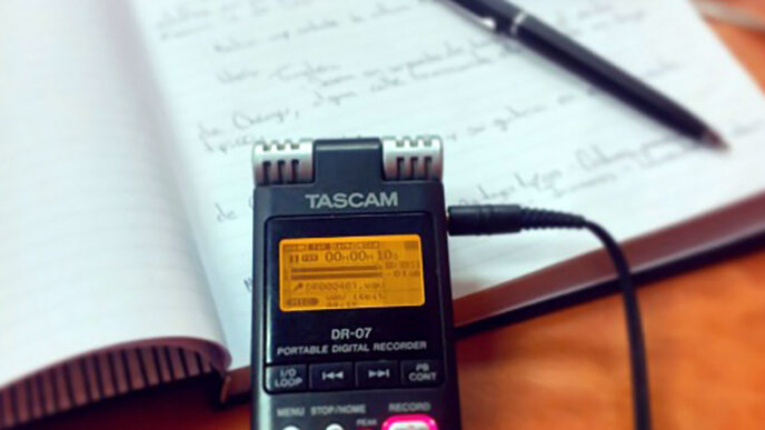 Tools of the storyteller's trade: a digital recorder and notebook.