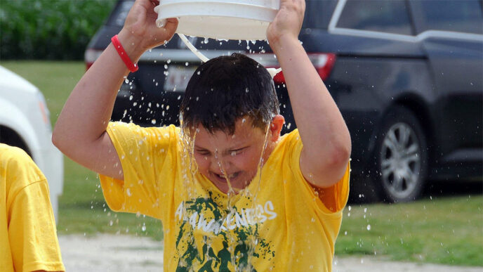 Young man holding bucket for the Ice Bucket Challenge.