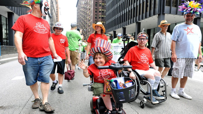 Members of Tellin' Tales Theatre at the Disability Pride Parade and Rally|Paula from Washington Heights at the Disability Pride Parade and Rally|Kevin at the Disability Pride Parade and Rally|Wanda and Kim at the Disability Pride Parade and Rally|Liz from Rogers Park at the Disability Pride Parade and Rally|Glenn and Sarah from Grayslake with their children at the Disability Pride Parade and Rally|Daniel from LaGrange at the Disability Pride Parade and Rally|Colleen from Western Springs with service dog Fiesta at the Disability Pride Parade and Rally|Rachel from Park Ridge and her friend Brandon at the Disability Pride Parade and Rally|Scott Nance of the Parade organizing committee.