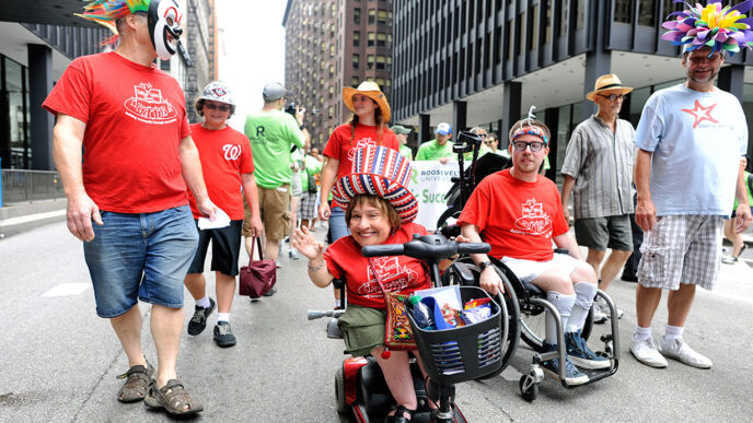 Members of Tellin' Tales Theatre at the Disability Pride Parade and Rally|Paula from Washington Heights at the Disability Pride Parade and Rally|Kevin at the Disability Pride Parade and Rally|Wanda and Kim at the Disability Pride Parade and Rally|Liz from Rogers Park at the Disability Pride Parade and Rally|Glenn and Sarah from Grayslake with their children at the Disability Pride Parade and Rally|Daniel from LaGrange at the Disability Pride Parade and Rally|Colleen from Western Springs with service dog Fiesta at the Disability Pride Parade and Rally|Rachel from Park Ridge and her friend Brandon at the Disability Pride Parade and Rally|Scott Nance of the Parade organizing committee