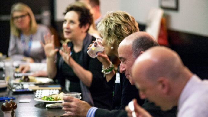 Guests enjoy conversation at an On the Table mealtime event.