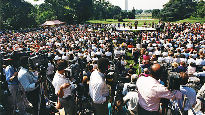 Signing ceremony on the South Lawn of the White House for the Americans with Disabilities Act (ADA)|Kevin Irvine and Karen Tamley at the March for Justice Rally in 2000 in Washington D.C.|Disability leaders march down Madison Avenue in support of the ADA in 1993|Activists with the Wheels of Justice campaign can be seen marching from the White House to the U.S. Capitol Building|Wheels of Justice campaign on the move|Justin Dart.