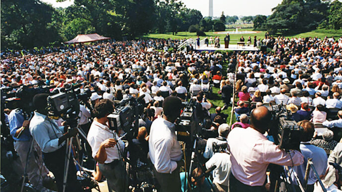 Signing ceremony on the South Lawn of the White House for the Americans with Disabilities Act (ADA)|Kevin Irvine and Karen Tamley at the March for Justice Rally in 2000 in Washington D.C.|Disability leaders march down Madison Avenue in support of the ADA in 1993|Activists with the Wheels of Justice campaign can be seen marching from the White House to the U.S. Capitol Building|Wheels of Justice campaign on the move|Justin Dart