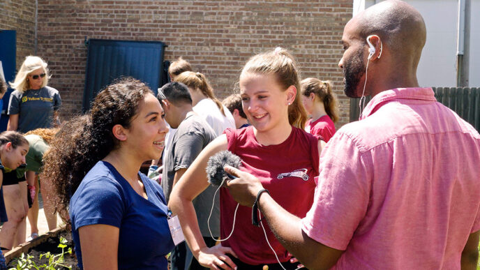 CHIRP Radio's Christopher Johnson interviews two young volunteers planting a schoolyard garden.