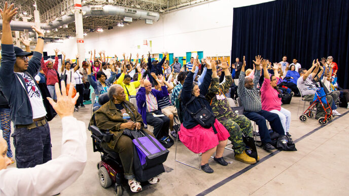 Individuals listen to a speaker at the Access Chicago Expo.