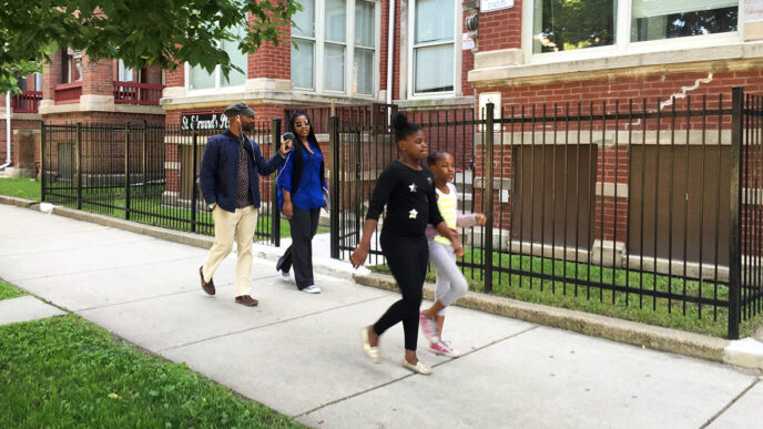 Washington Park resident Sheenita Robinson and her daughters lead CHIRP reporter Christopher Johnson on a neighborhood tour.