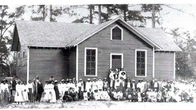 Historic photo of town residents posing in front of newly built Rosenwald School in Alabama