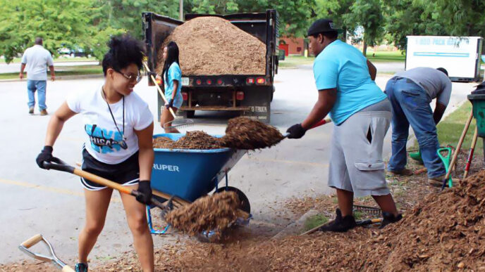 Students apply mulch to neighborhood trees at the Save Chicago Day service projects|.