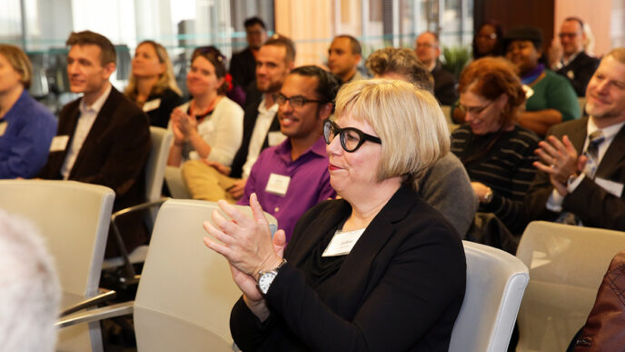 Attendees applaud at the LGBT Community Fund's first-ever grant reception|Representatives from the Chicago Black Gay Men's Caucus accept a grant check at the LGBT Community fund grant reception|.