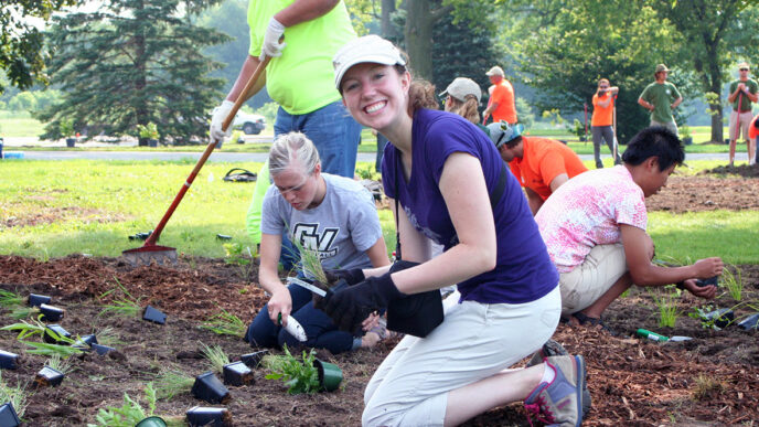 Catherine Game and other volunteers planting perennials.