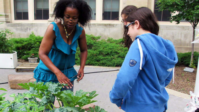 Sonya Harper shows students a community garden in Englewood.