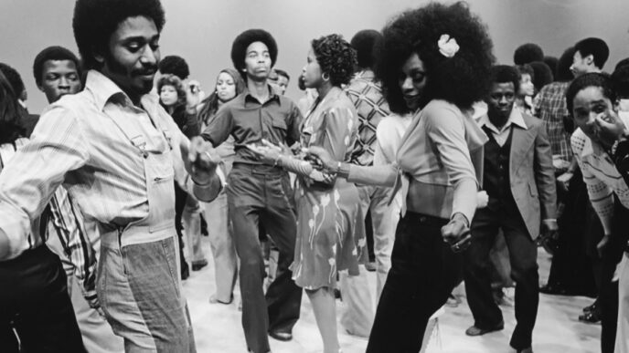 Photo from the 1970s of a group of men and women dancing|Archival photo portrait of George E. Johnson Sr.