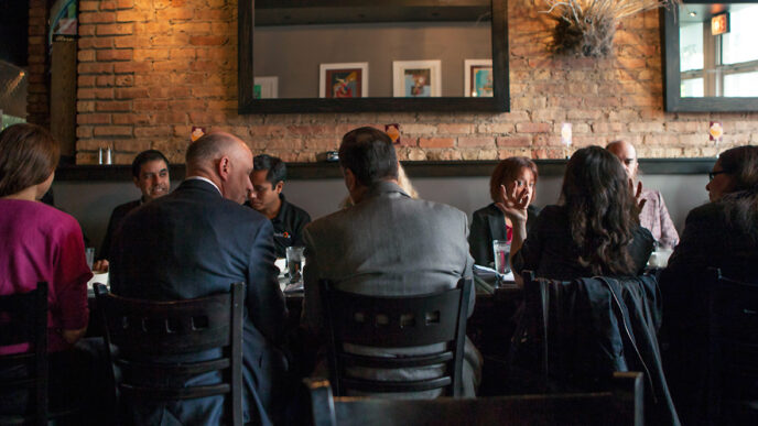 Guests in conversation around a breakfast table during On the Table 2015.