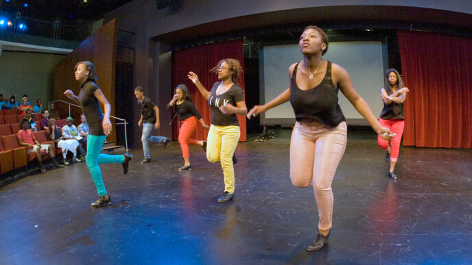 A group of tap dancers on stage at the Arts Infusion Expo.