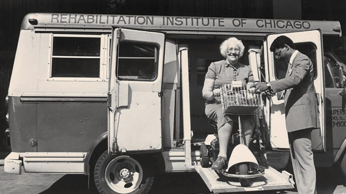 Archival photo shows women using mobility scooter entering a Rehabilitation Institute of Chicago van|.