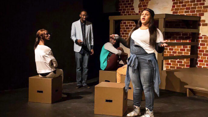 Four young performers on a stage|.