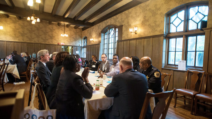 Community and police leaders gather around breakfast tables at On the Table 2016|A group i conversation over breakfast at the Hull House Museum during On the Table 2016|Journalist Robin Robinson at On the Table 2016|.