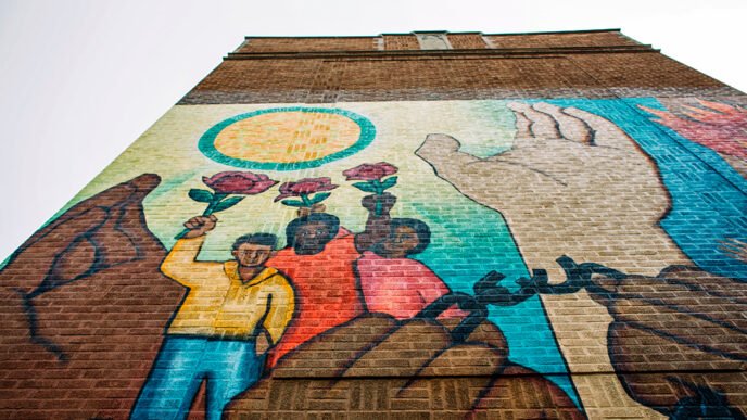 A mural in Humboldt Park depicting hands breaking free of chains