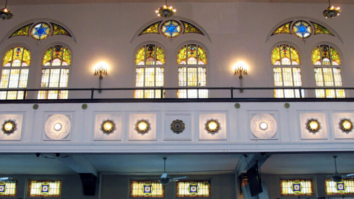 Stained glass windows at the Stone Temple Missionary Baptist Church depicting stars of David|Members of a church choir and congregation singing|Flyer promoting a March For Freedom on July 25.