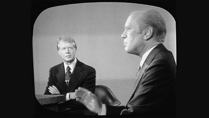 Television screen showing Jimmy Carter and Gerald Ford at podiums during their 1946 presidential debate|Portrait of Charles Benton.