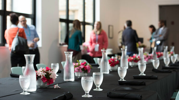 A table set with flowers and carafes of water