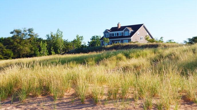 Vacation home among grassy dunes.