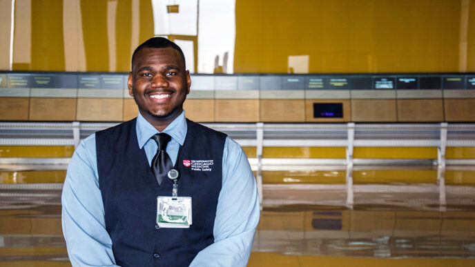 Charles Gentry at the University of Chicago Medical Center|Gentry standing beside a sign on the University campus|Gentry sits at a security desk and greets a visitor.