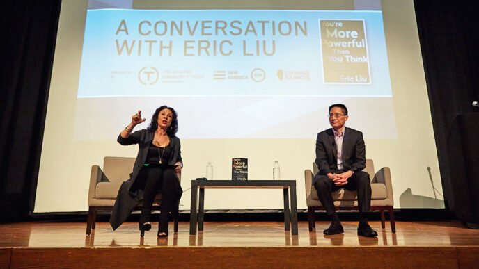 Maria Hinojosa and Eric Liu seated on stage|Maria Hinojosa and Eric Liu photographed from behind.