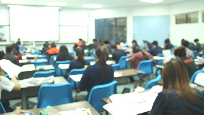 Students seated at desks in a high school classroom.
