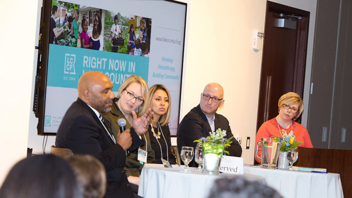 Five people seated in a row for a panel discussion.