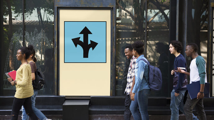 Six teenagers carrying school books walk in pairs past a large sign showing arrows in many directions.