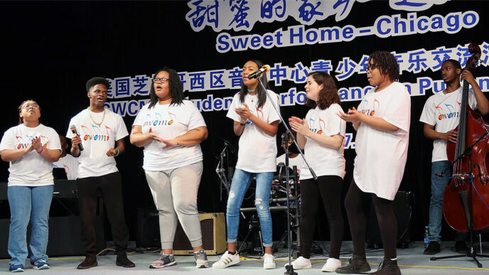 A group of young musicians perform on a stage.