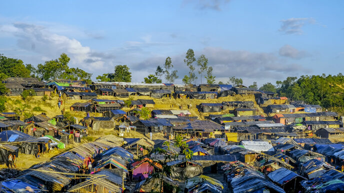 Rows of tents and bamboo shelters.