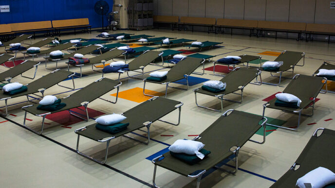 Rows of empty cots in an emergency shelter await people displaced by Hurricane Florence.