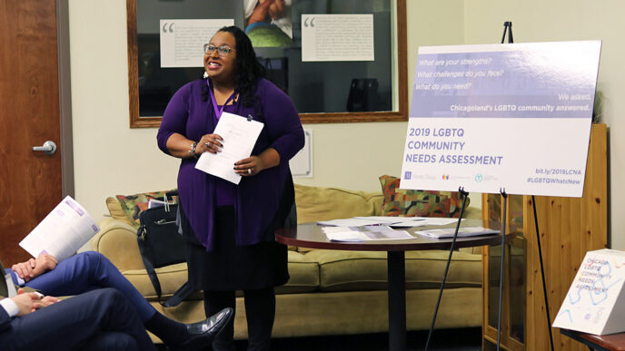 A smiling woman holds a report.