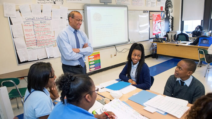 A man stands in a classroom.