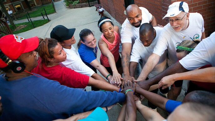 A group of runners stand in a circle